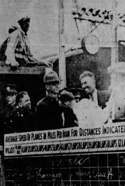 Mamer (R) meets Major John Fancher (in uniform) at the finish-line scoreboard. (The Spokesman-Review)